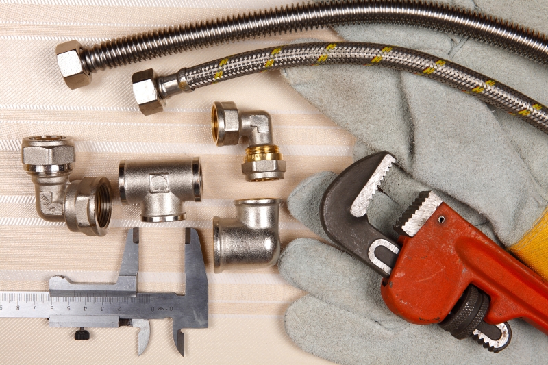 Plumber working on pipes in a Streatham home